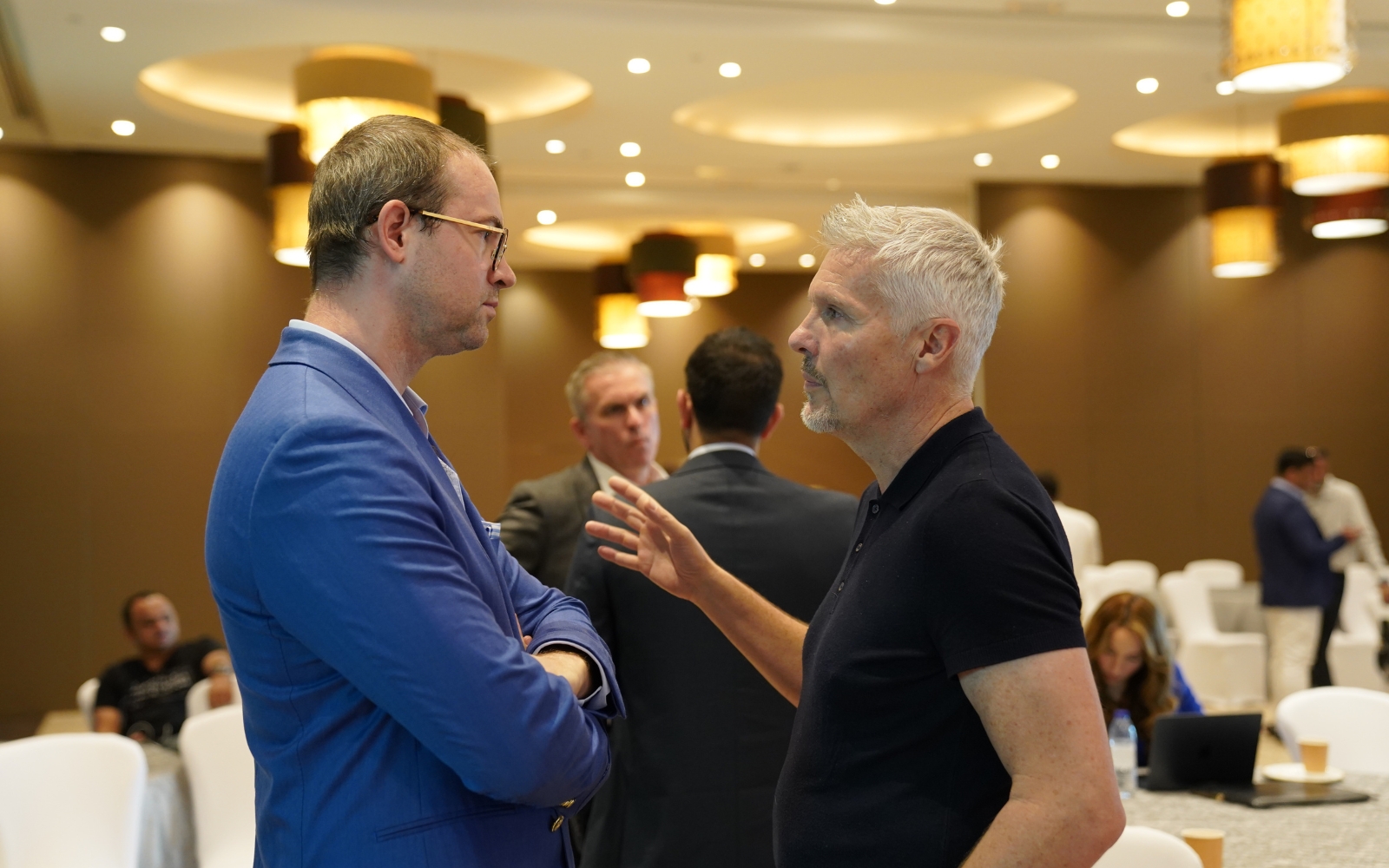 Two delegates in conversation during a break between sessions