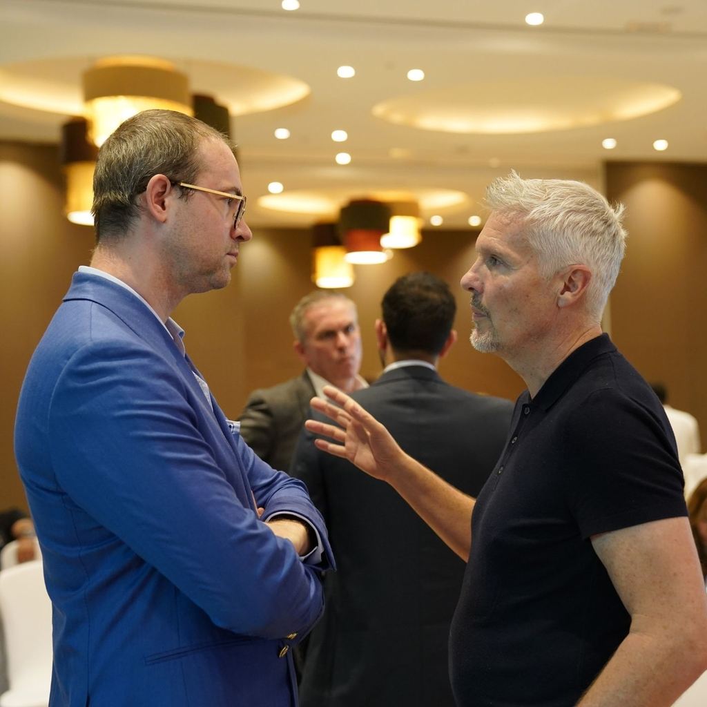 Two council delegates in conversation during a private session